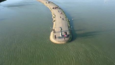 tourists visiting the historical monument of byrhtnoth statue in maldon, essex, uk