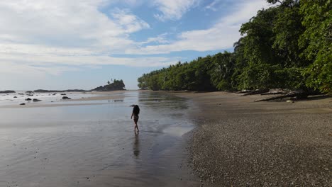 beautiful lady walking on a tropical paradise beach by herself in sun