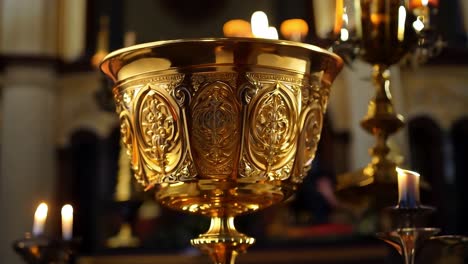 golden chalice resting on an altar, surrounded by burning candles, enhances the atmosphere of worship in a church