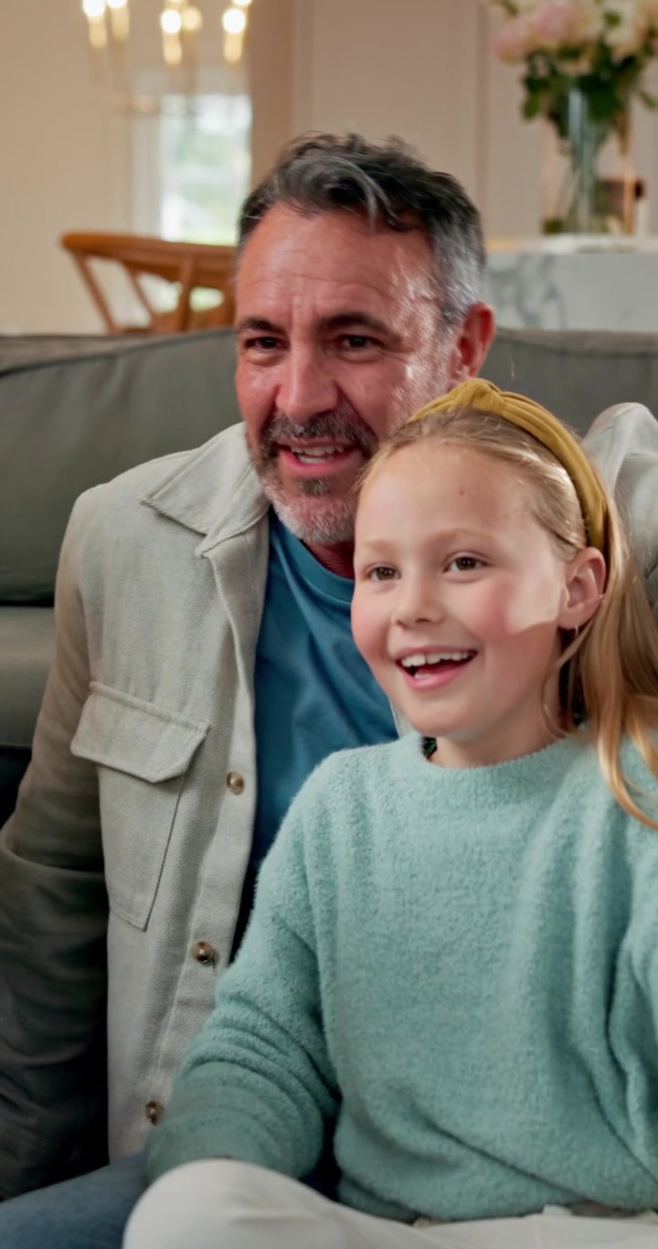 Father and Daughter Giving Each Other a High Five at Home