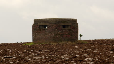 wide shot of ww2 pillbox next to happisburgh lighthouse at happisburgh in march 2024