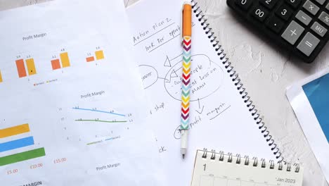 Financial-graph,-calculator-and-notepad-on-table