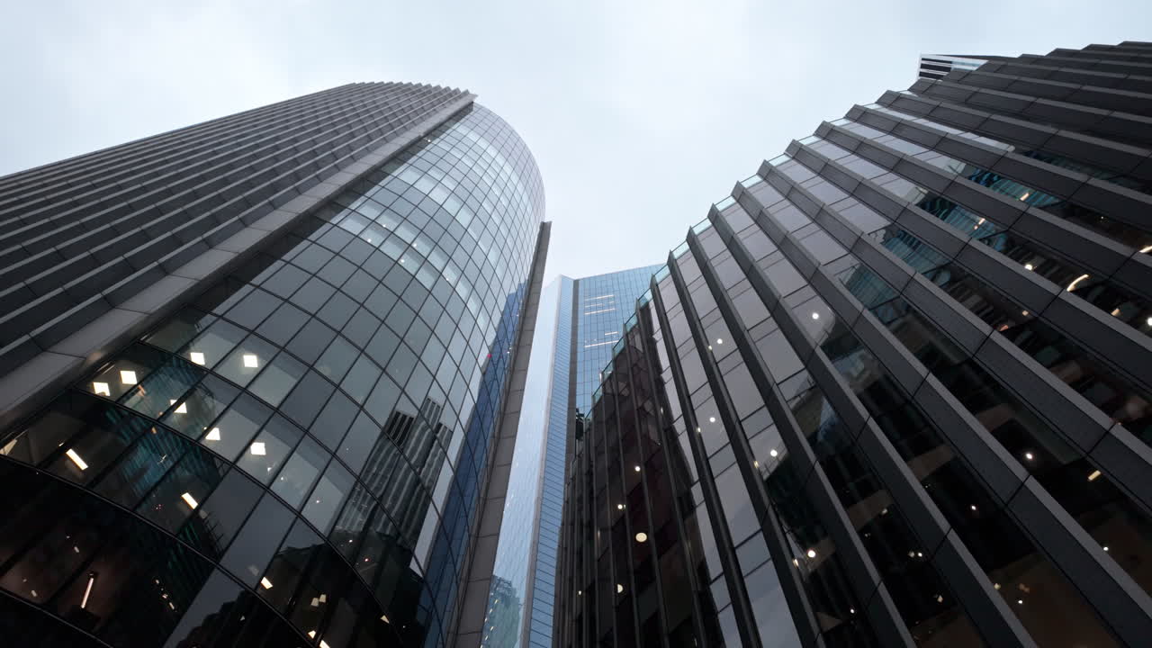 Skyscrapers in London's financial district on a cloudy day, urban energy