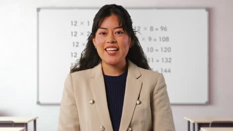 Close-Up-Shot-Of-Female-Teacher-In-Classroom-Standing-In-Front-Of-Board-Teaching-Elementary-Maths-Lesson