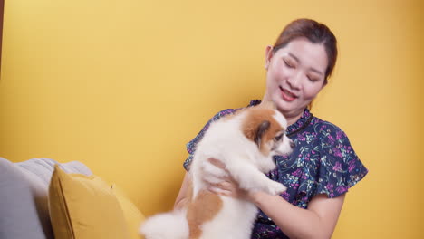 asian women play with puppy pets hold a