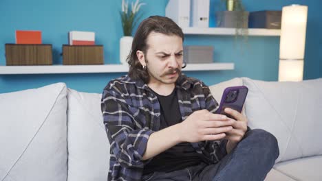 the man looking at the phone is surprised and angry. social media.