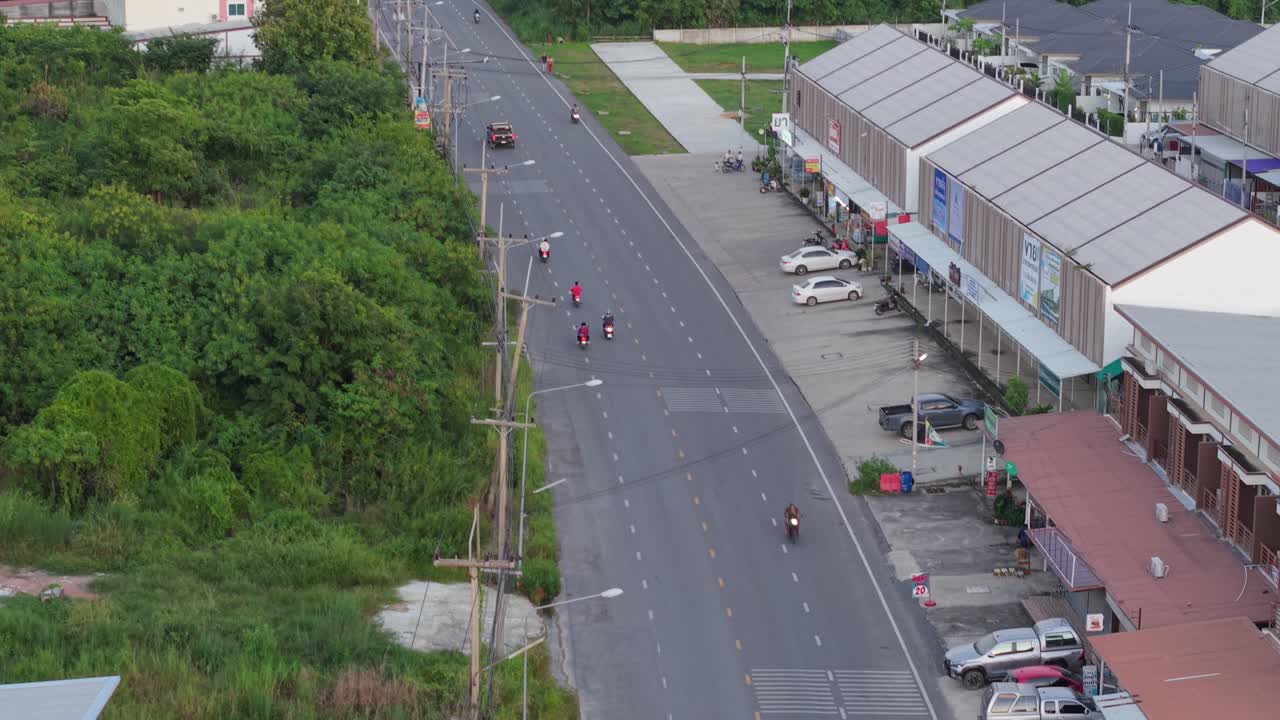 Street view of a town with motorcycles and cars