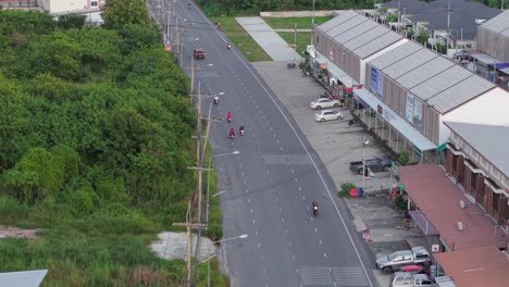 street view of a town with motorcycles and cars