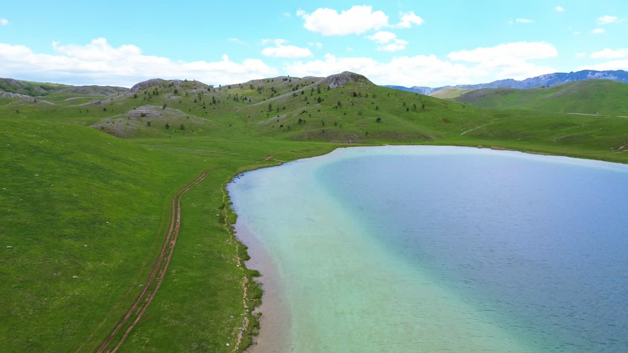 Vrazje jezero vivid blue green hue glacial lake in Durmitor National Park on Jezerska plateau, Aerial closeup
