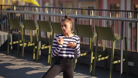 young woman practicing yoga on a rooftop cafe
