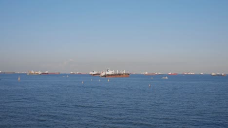 Tracking-Shot-Of-Cargo-Vessel-On-The-Ocean-Under-Sunny-Day