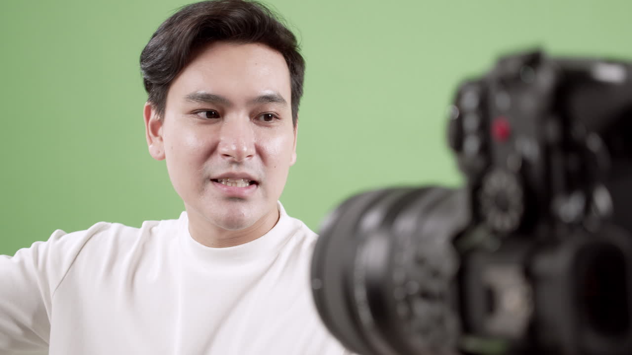 A young man engages in a video tutorial in a home studio showcasing the creative process behind content creation.