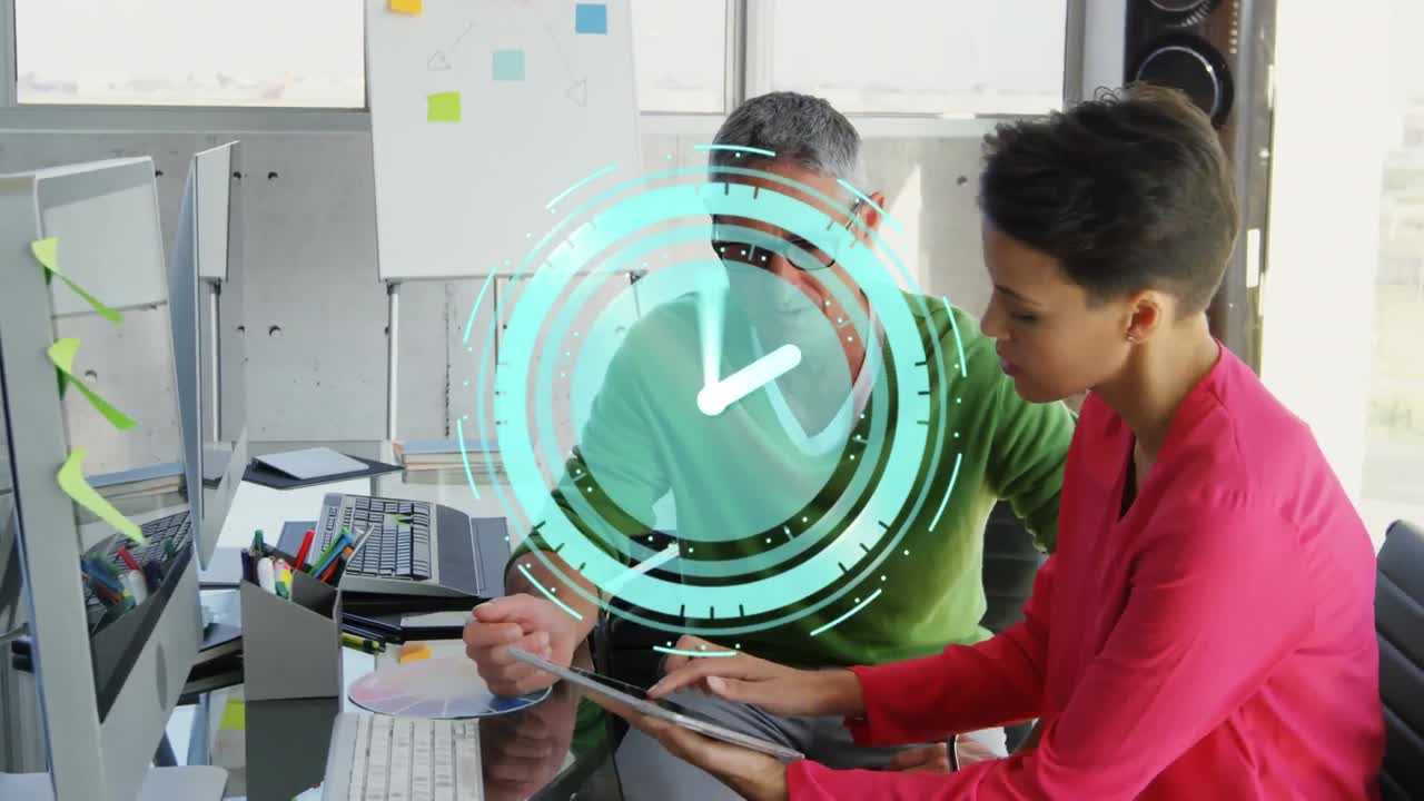 Animation of digital clock with hands moving fast over woman and man at office desk using tablet