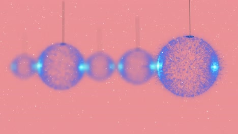 animación de bolas de navidad sobre la nieve que cae sobre un fondo rosa