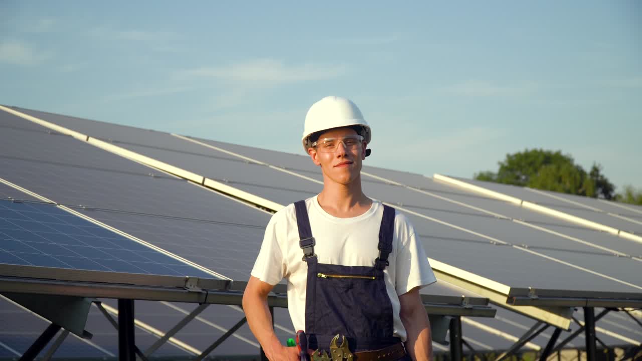 Solar panel technician working with solar panels at sunset. The future is today
