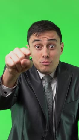 angry businessman pointing and expressing frustration on green screen