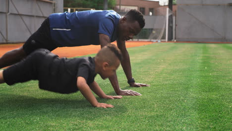 father and son doing push-ups together