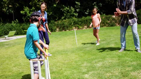 happy family playing cricket