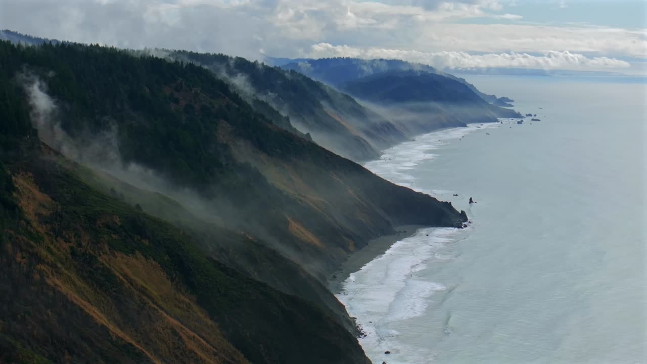 USAL Beach Sinkyone Wilderness Northern California aerial drone rugged untouched coastline mist rain evaporating morning remote untouched black sand waves crashing bluffs Lost Coast Trail circle left