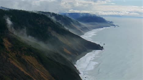 usal beach sinkyone wilderness northern california aerial drone rugged untouched coastline mist rain evaporating morning remote untouched black sand waves crashing bluffs lost coast trail circle left