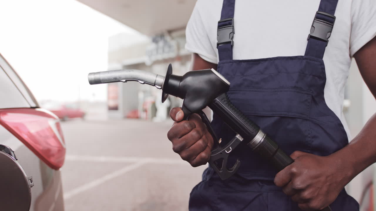 Man refueling a car at a gas station