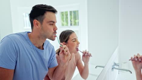 Couple,-brushing-teeth-and-morning-by-mirror