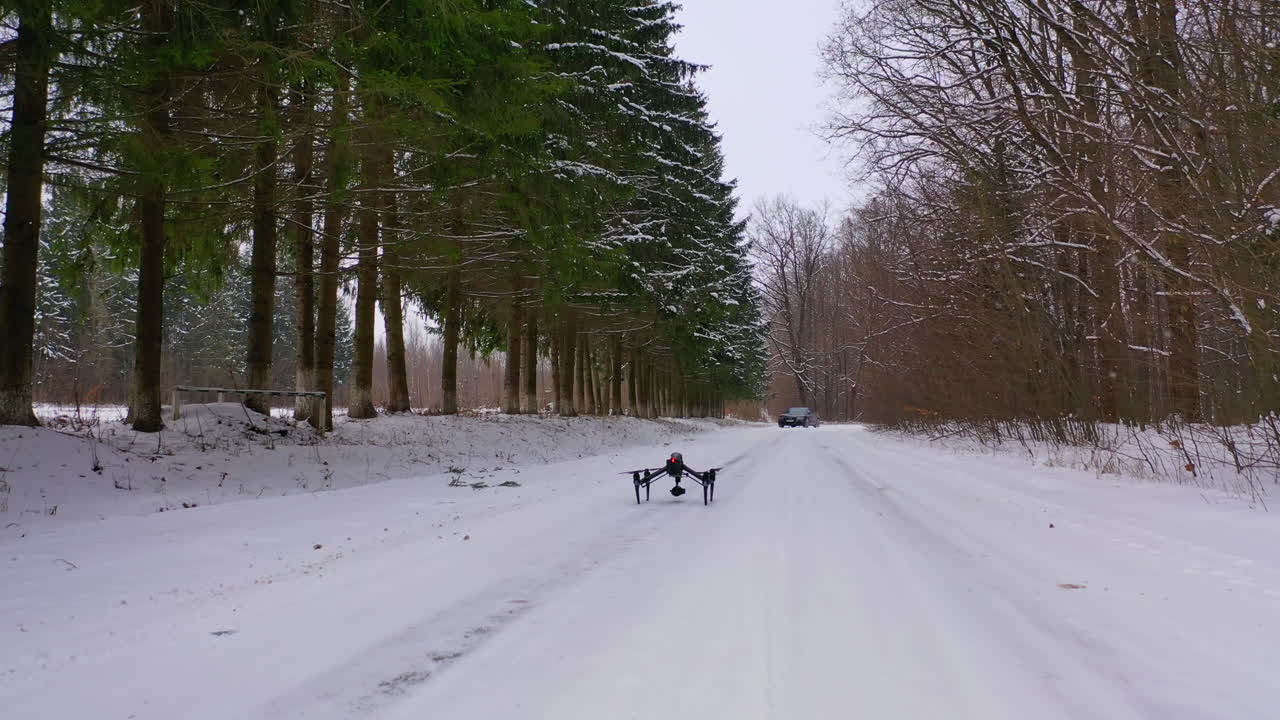Drone outdoors in winter landscape. View of standing drone on winter road