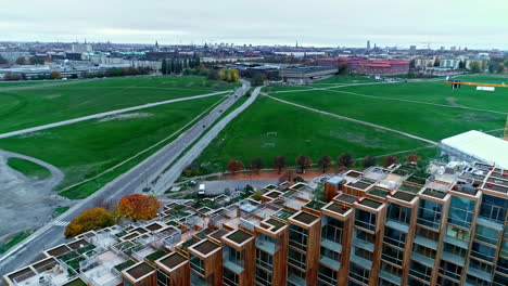 Flying-Above-Unique-Luxury-Apartment-Building-79-And-Park-In-Stockholm,-Sweden-During-Fall-Season