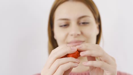 Woman-eating-chocolate-with-heart-in-close-up.-Eating-chocolate.