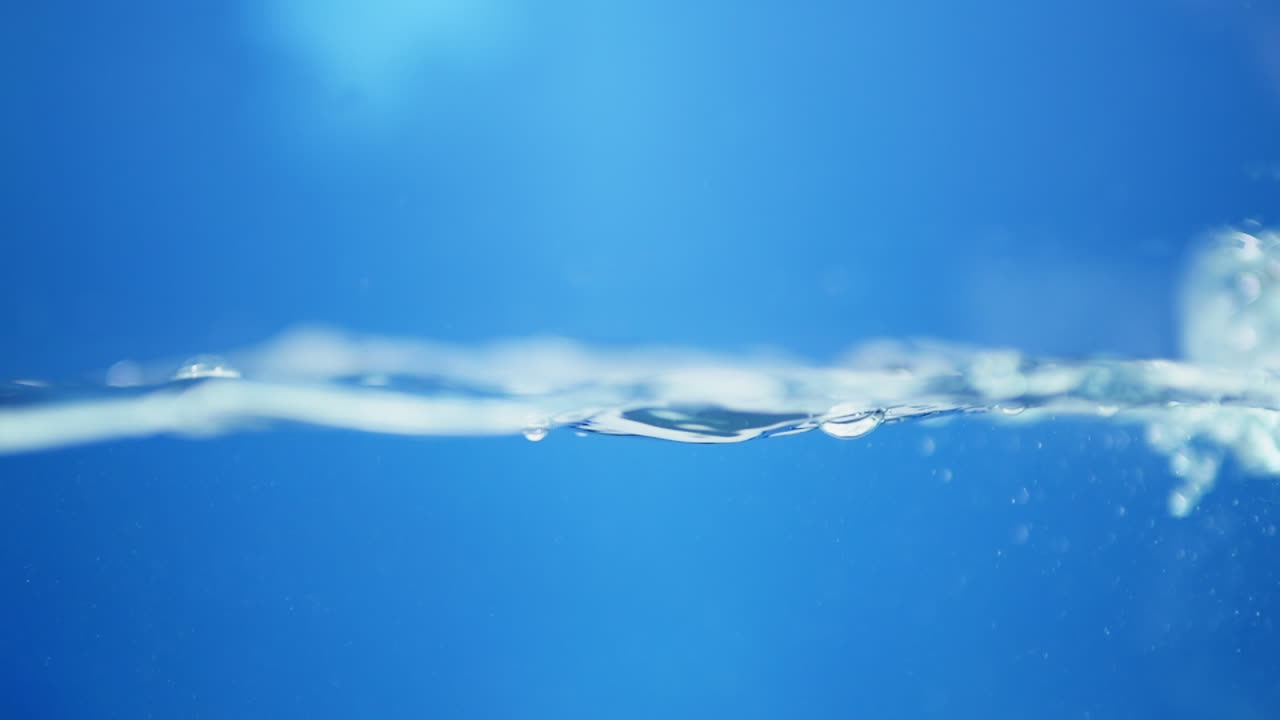 Engaging slow-motion close-up of waves on water, emphasizing the refreshing qualities of clean drinking water and its clarity.