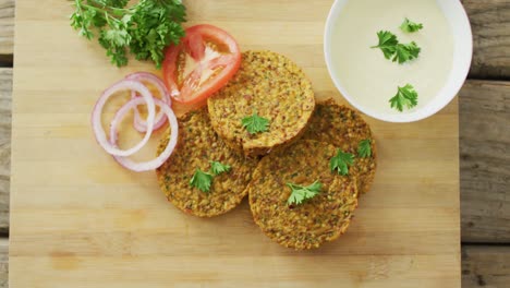 video of fresh vegetables and vegetarian burgers over wooden background