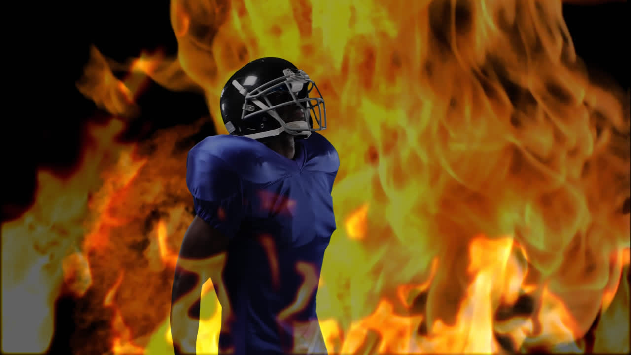 Male rugby player against fire in background