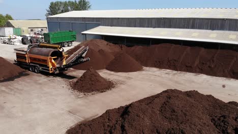 composted soil in piles on a farm yard