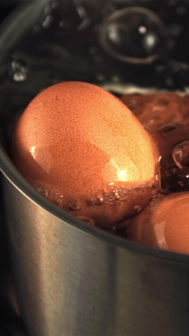 Brown Eggs Boiling in a Metal Pot