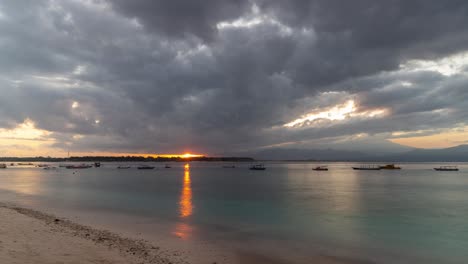 sunrise over tropical island beach with boats