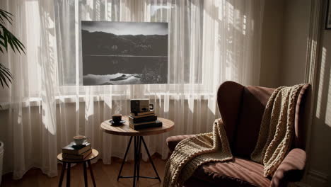 a cozy living room scene with sunlit window and black and white nature art
