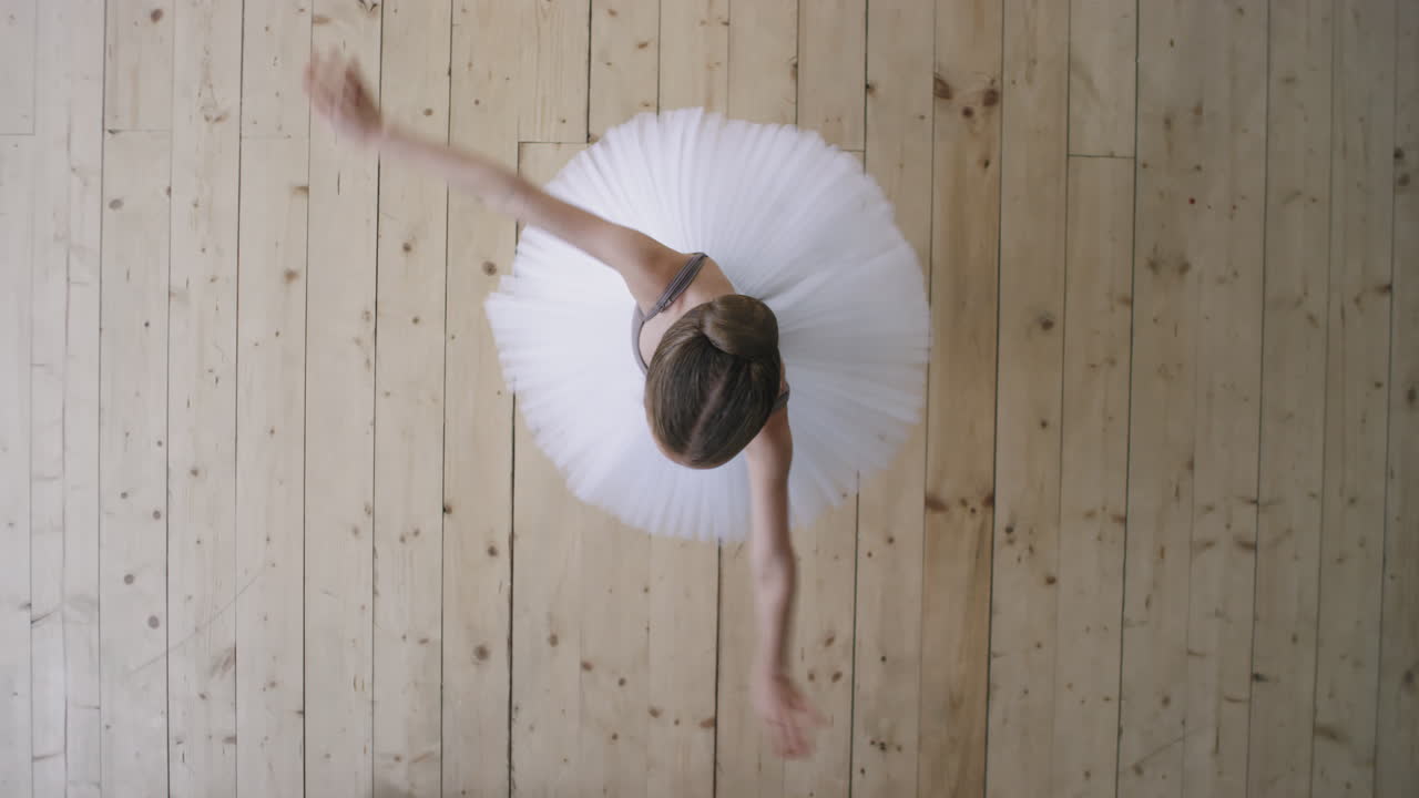 Top View Of Little Ballerina Whirling While Dancing