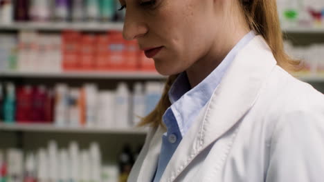 woman holding pills and paper at the pharmacy