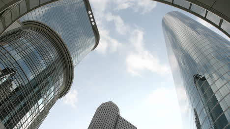 slow upward pan of the houston oil company buildings seen from beneath an arch