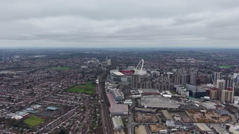 wembley stadium and surrounding city skyline at sunset in wembley, london, uk. aerial shot
