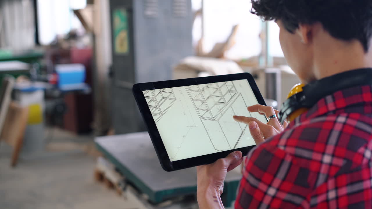 Woodworker reviewing digital plans on a tablet