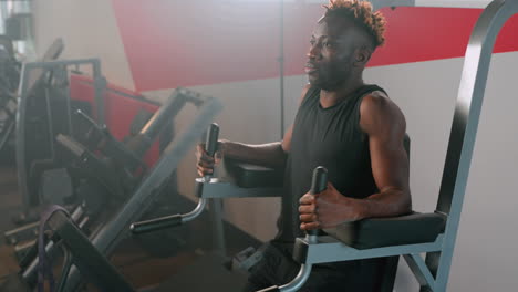 man working out on a sit-up machine in a gym