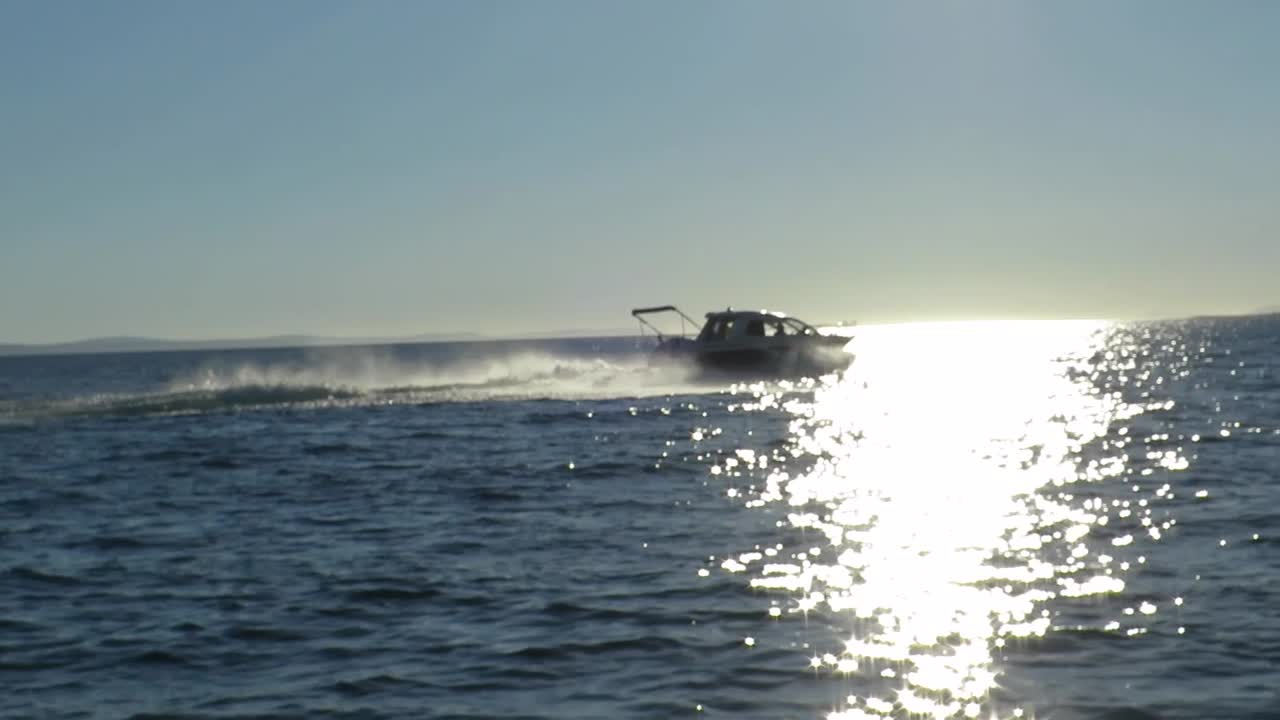 Fast boat passing on the sea in slow motion