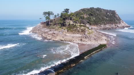 Drone-aerial-view-of-the-San-Nicolás-island-at-the-beach-of-Lekeitio-in-the-Basque-Country