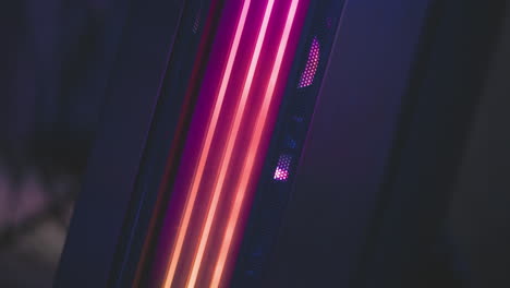 close up of speaker system with glowing multicolored circular lights creating radiant tech atmosphere, showcasing vivid rgb hues in modern dark studio setup with soft reflections