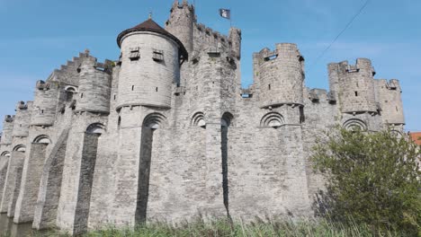 a majestic medieval castle with stone towers and battlements under a clear blue sky