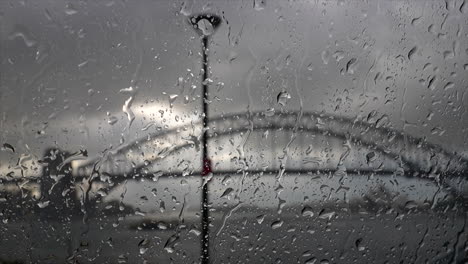 A-UTE-drives-by-as-raindrops-hit-the-windscreen-of-a-car-in-Sydney-harbour,-Australia