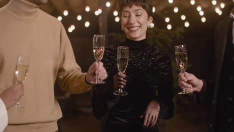 happy friends toasting and drinking champagne at new year's eve party 1