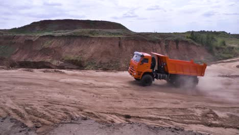 orange dump truck in a quarry