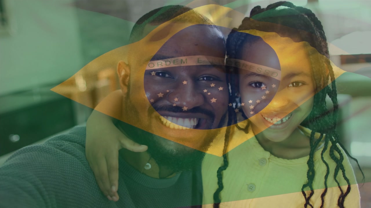 Animation of flag of brazil over africam americam man and his daughter
